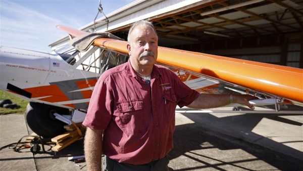 Greg Whisler stands beside the AOPA Sweepstakes Aviat Husky. Photo by Chris Rose.